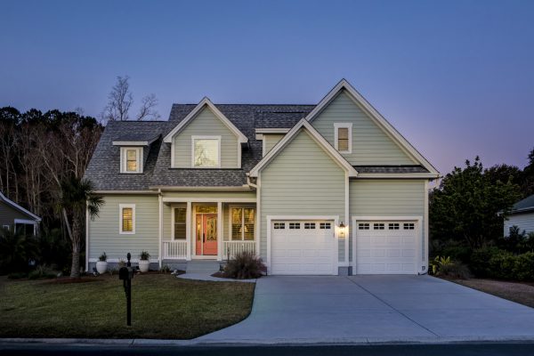 Front elevation of beautiful home lit up at twilight.