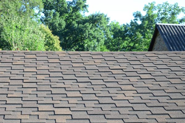 Modern roofing and decoration of chimneys. Flexible bitumen or slate shingles in rectangular shape in perspective.